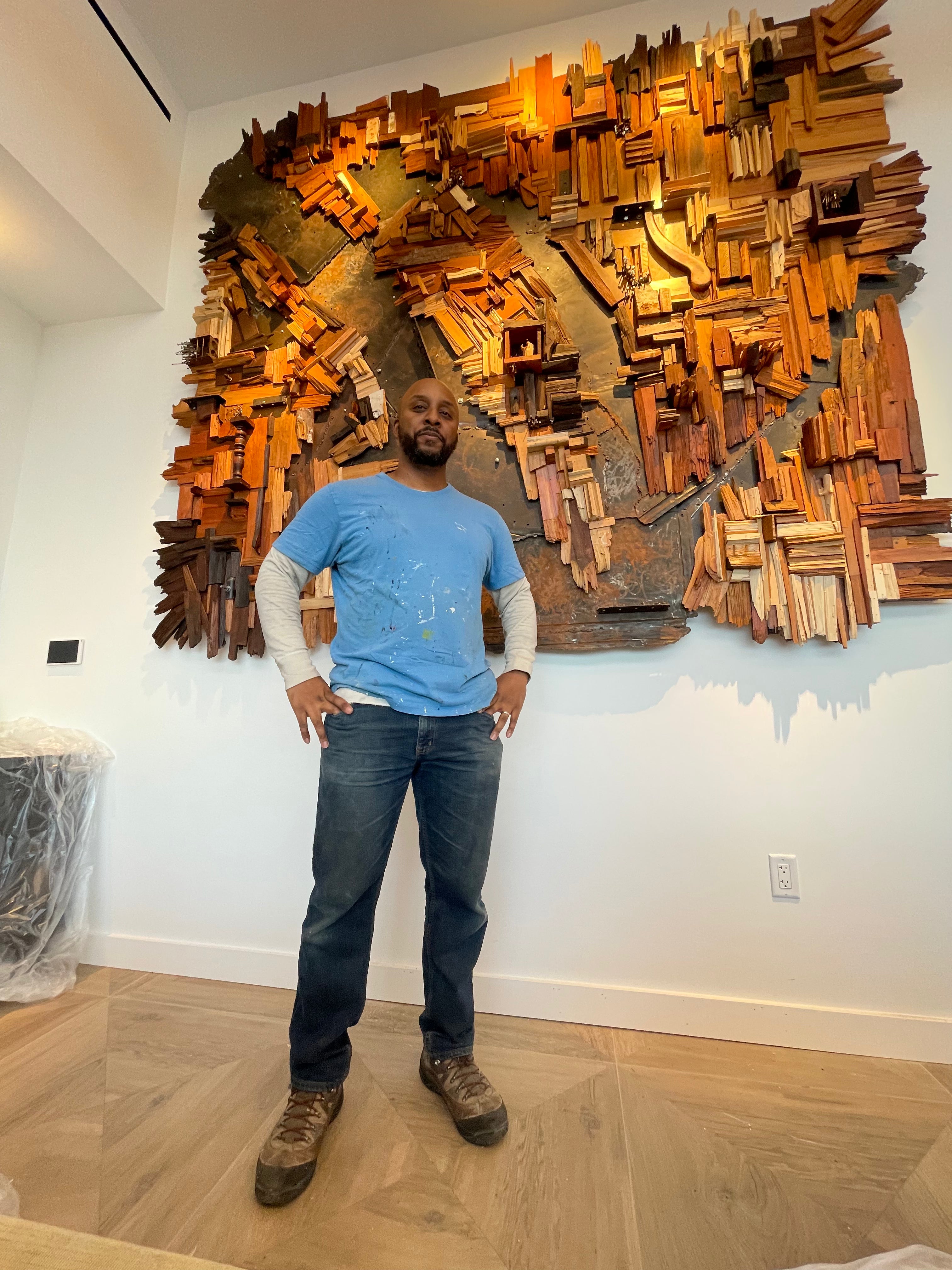 Morton Contemporary Art Advisory installing large reclaimed wood wall sculpture in Philadelphia residential project, mixed-media art installation
